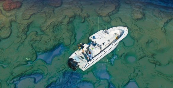 Vista aérea de un barco de pesca navegando sobre un fondo marino con relieve muy detallado, ilustrando la importancia de interpretar correctamente las estructuras del fondo con cartografía de alta resolución.
